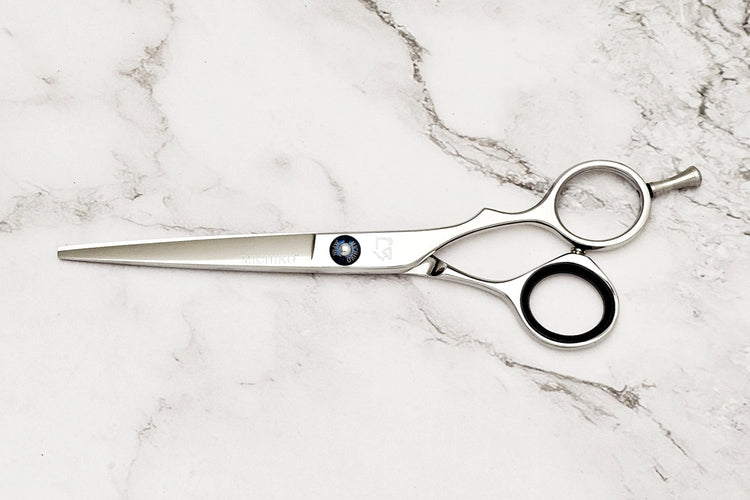 Hair cutting shears on a marble surface
