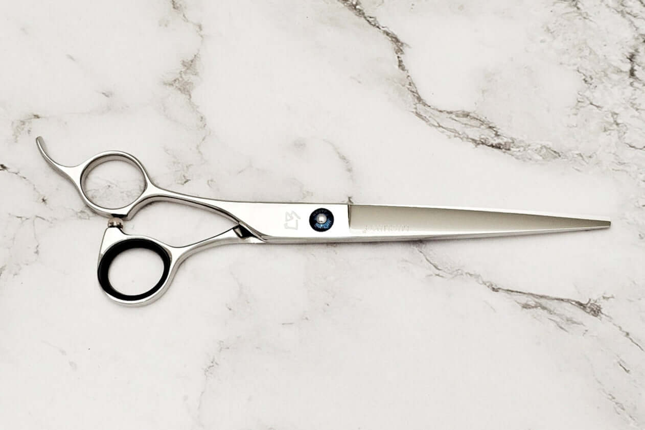 Lefty barber shears on a marble surface