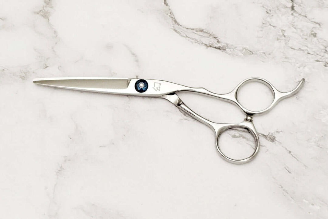 Hair scissors on a marble surface