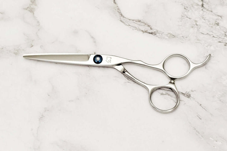 Hair scissors on a marble surface