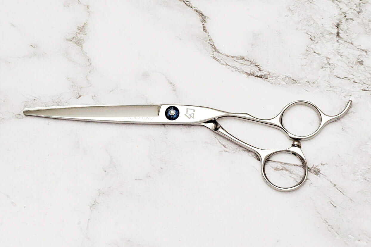 Barber scissors on a marble surface