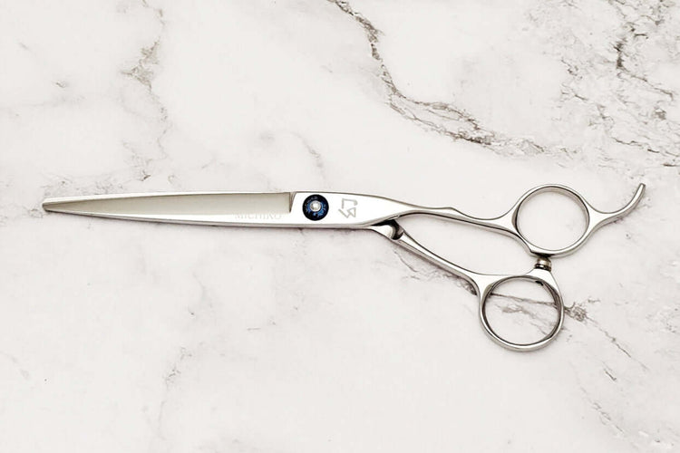 Barber scissors on a marble surface