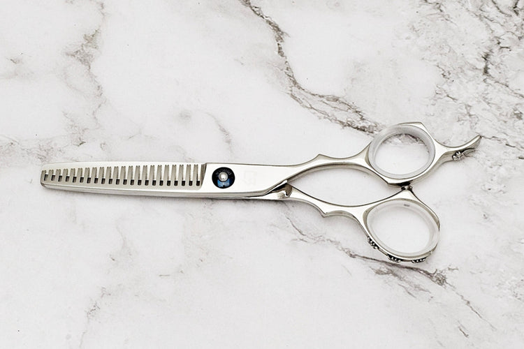 Hair thinning shears on white marble background