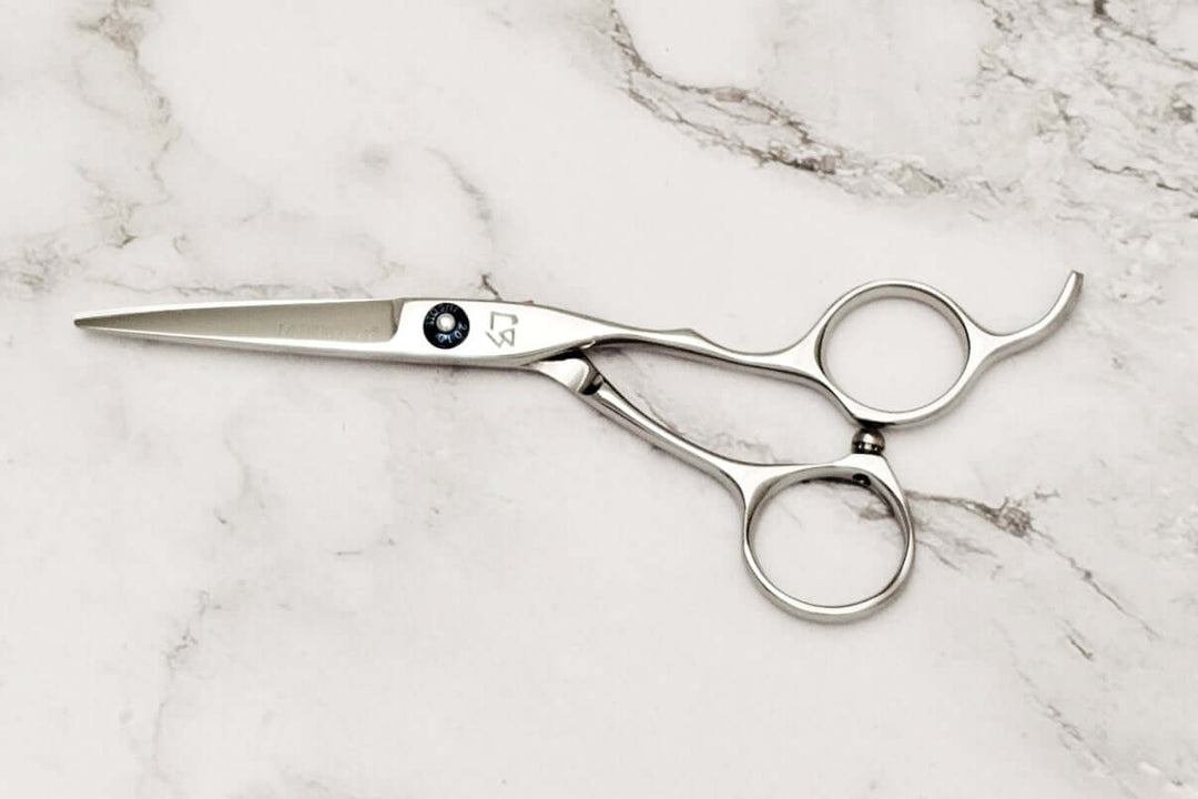 Hair cutting shears on a marble surface
