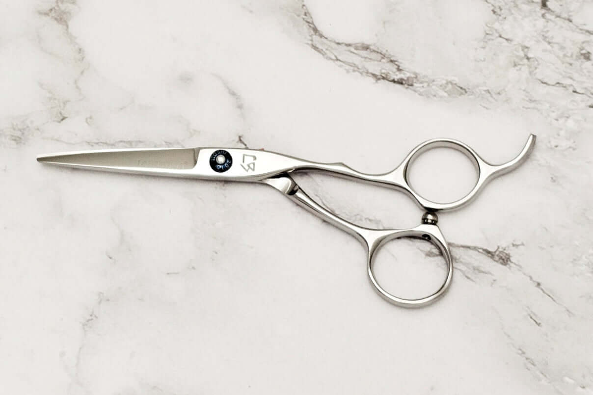 Hair cutting shears on a marble surface