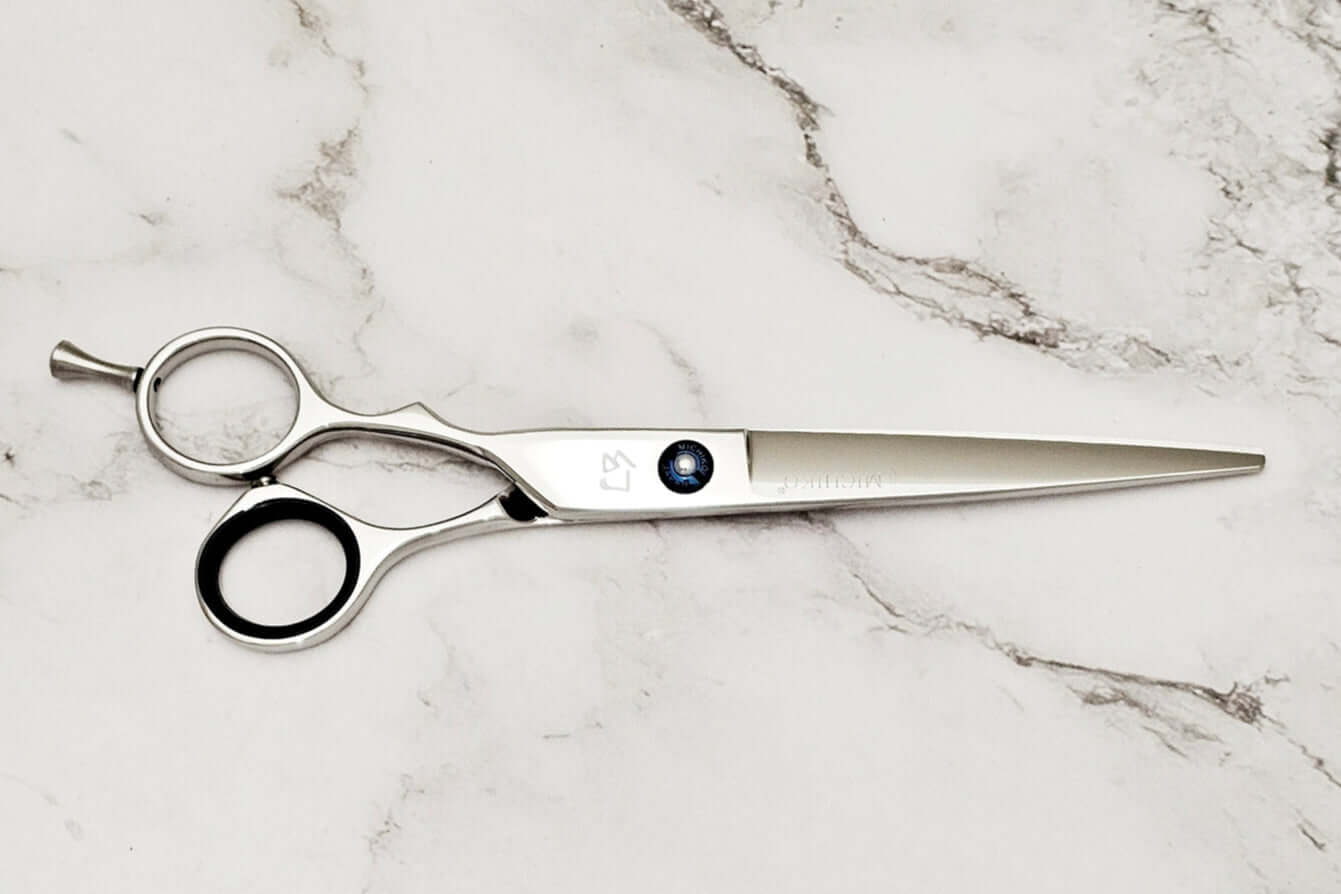 Lefty hair cutting shears on a marble surface