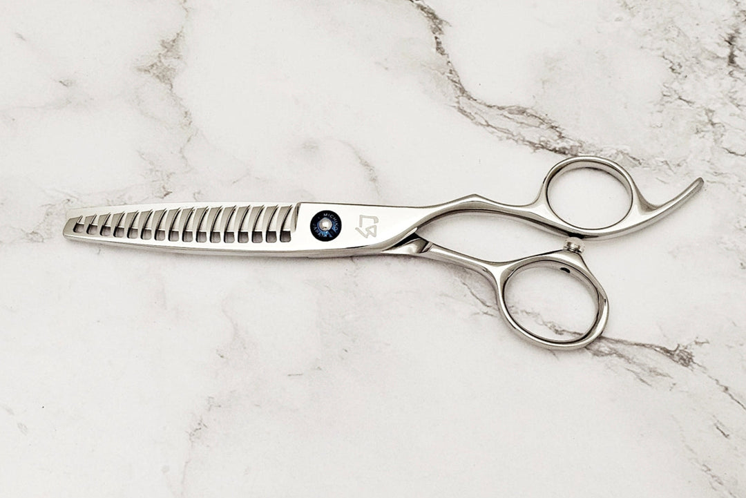 Texturizing hair shears on a marble surface