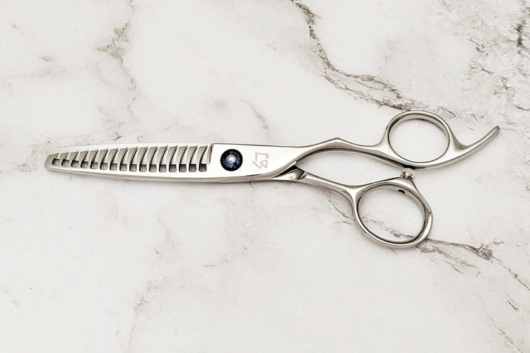 Texturizing hair shears on a marble surface