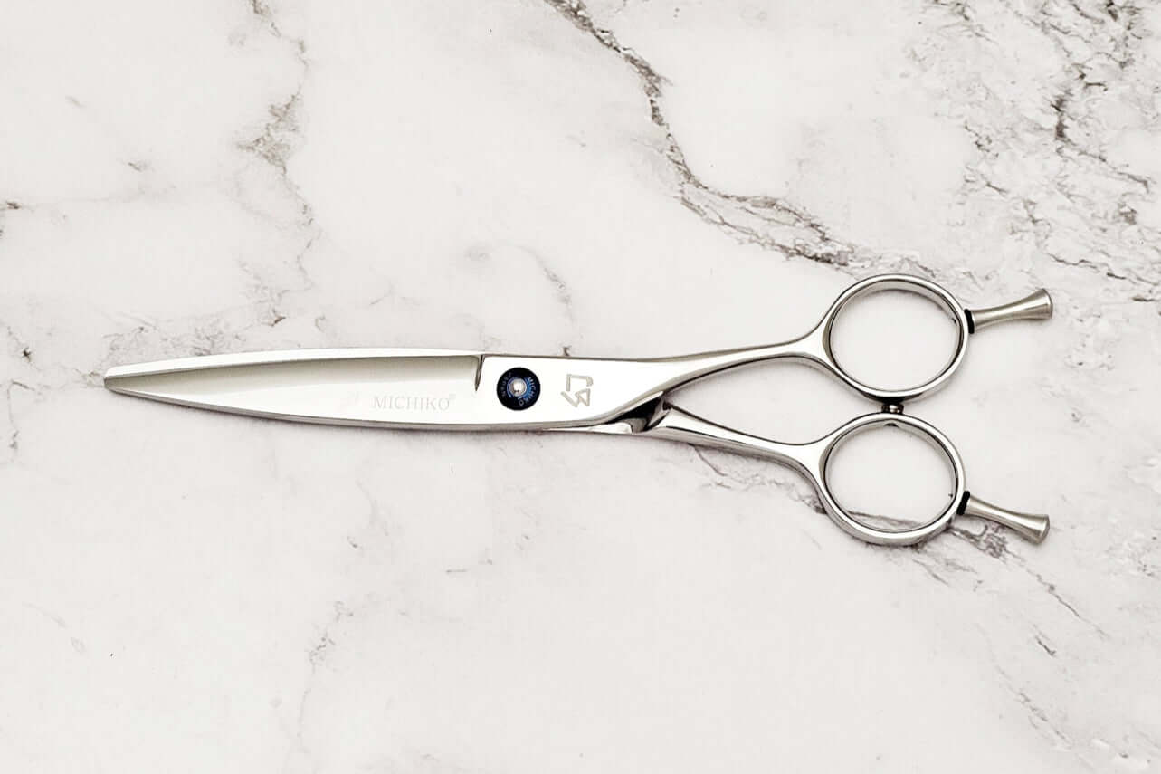 Slide cutting hair scissors on a marble surface