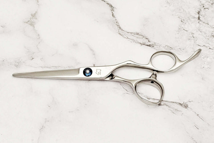 Hair scissors on a marble surface