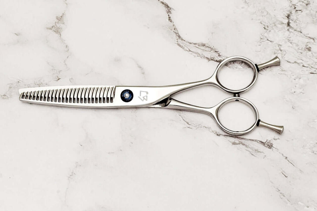 Hair thinning shears on a marble surface