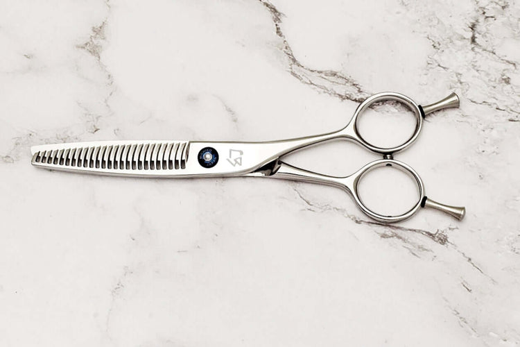 Hair thinning shears on a marble surface