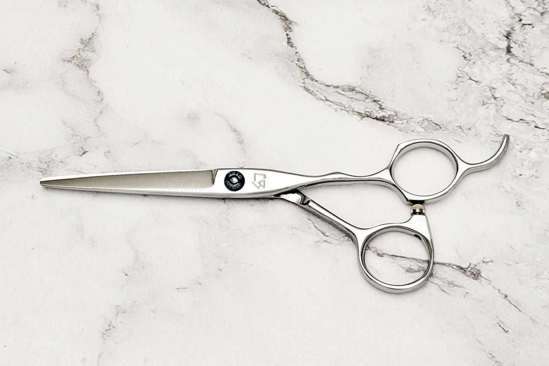Hair cutting shears on a marble surface