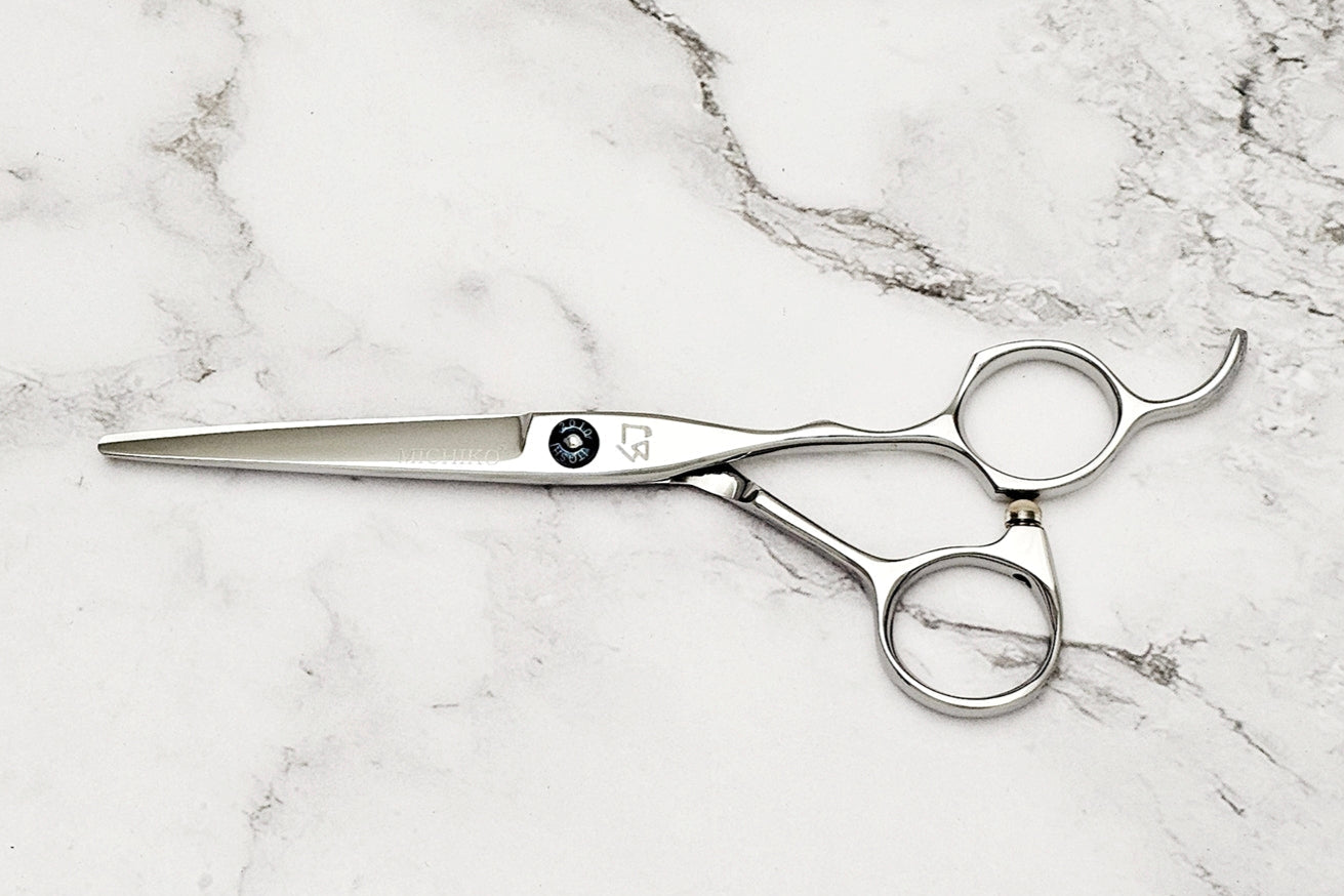 Hair cutting shears on a marble surface