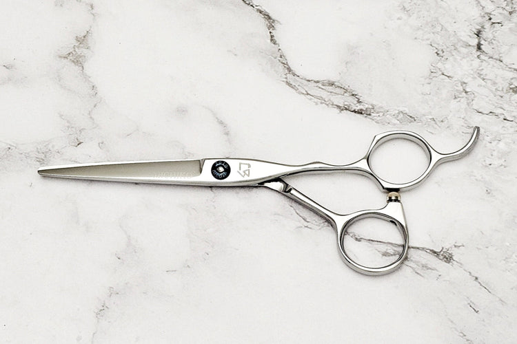 Hair cutting shears on a marble surface