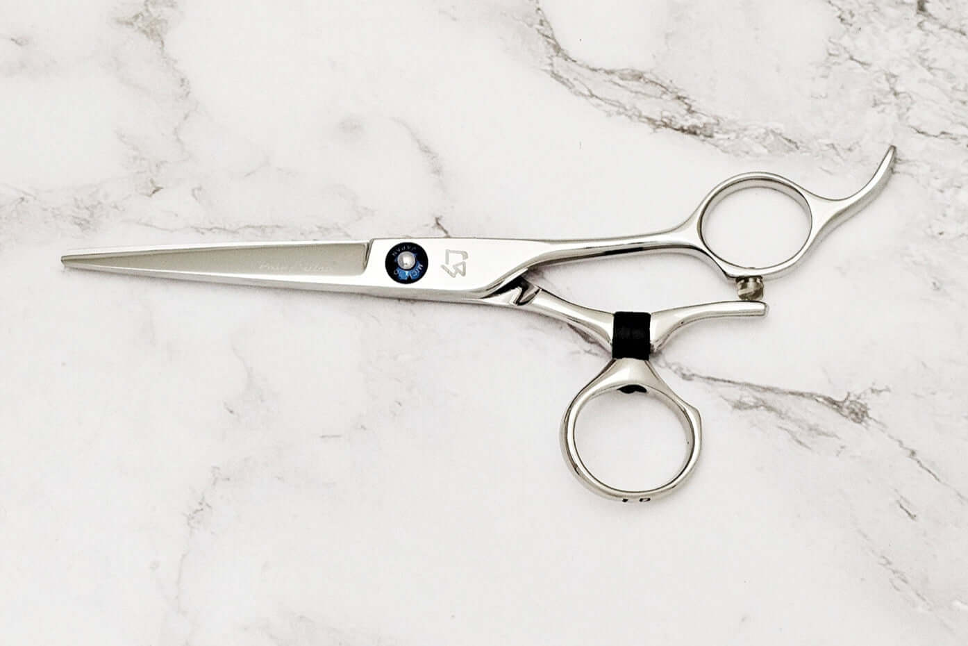 Swivel hair scissors on a marble surface