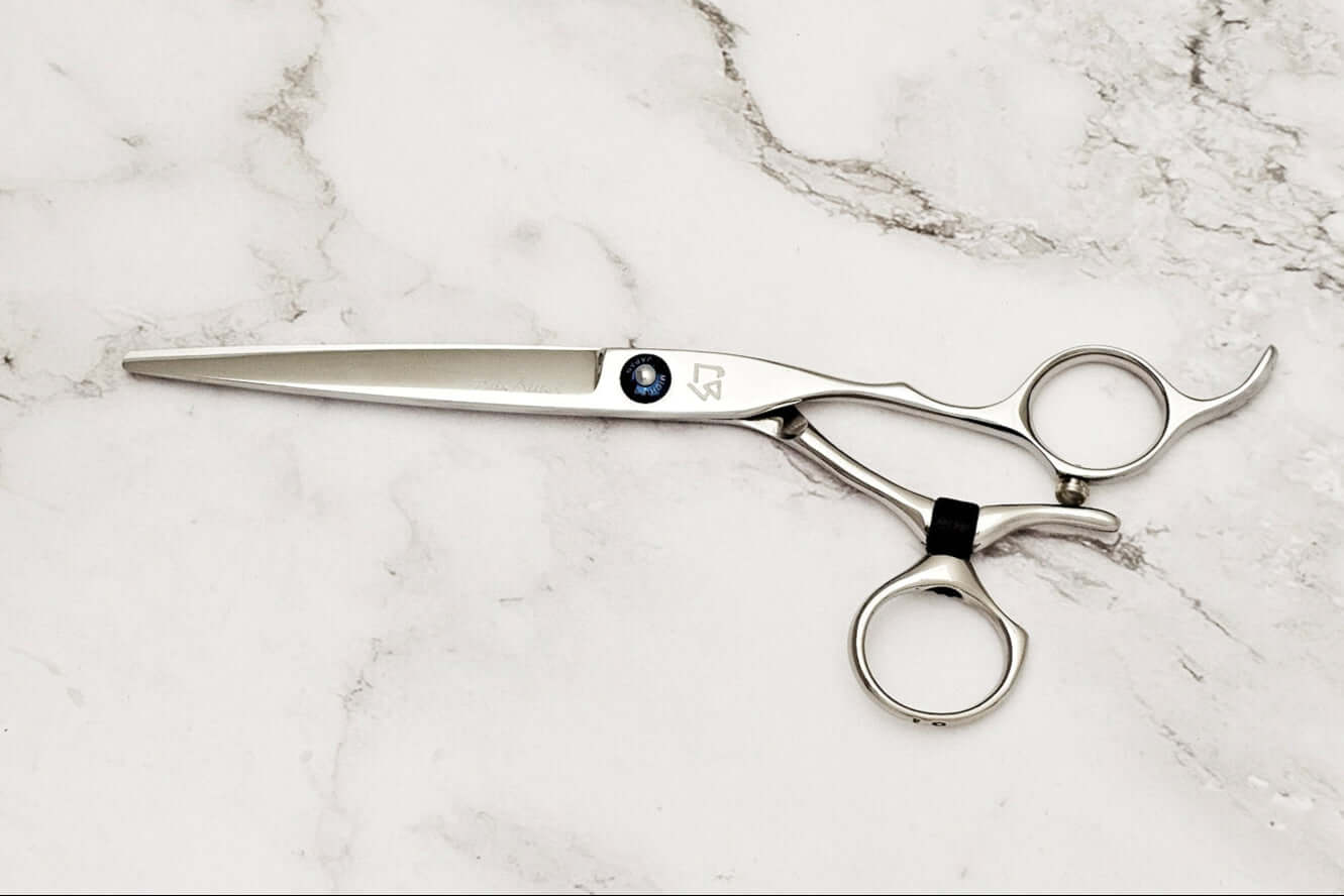 Swivel hair scissors on a marble background