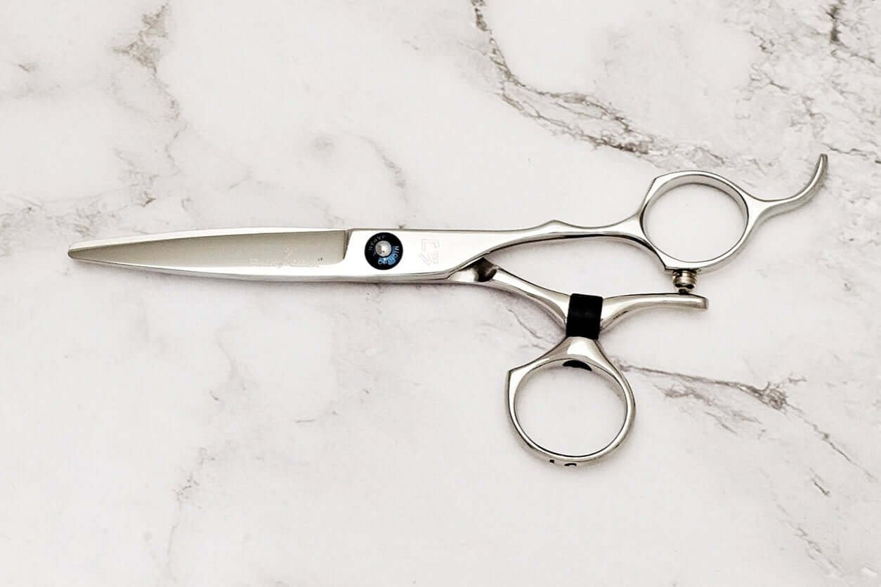Swivel hair scissors on a marble surface