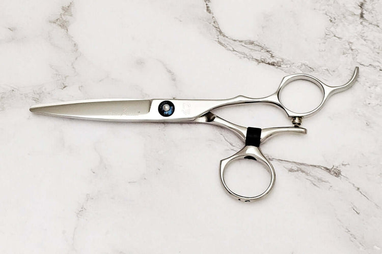 Swivel hair scissors on a marble surface
