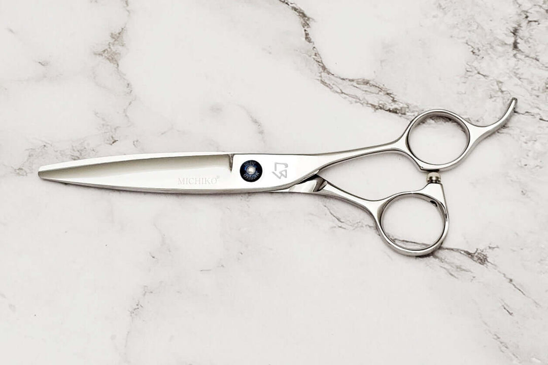 Hair scissors on a marble surface