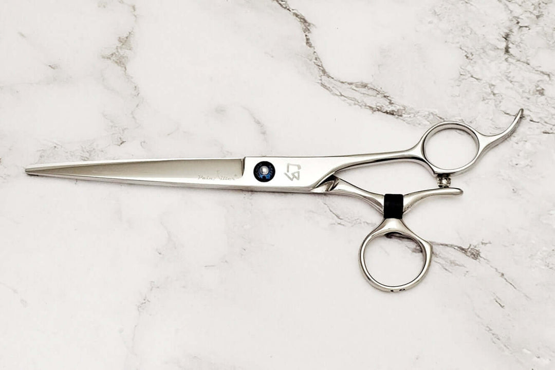 Swivel barber shears on a marble surface