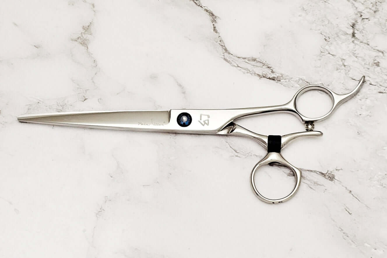 Swivel barber shears on a marble surface
