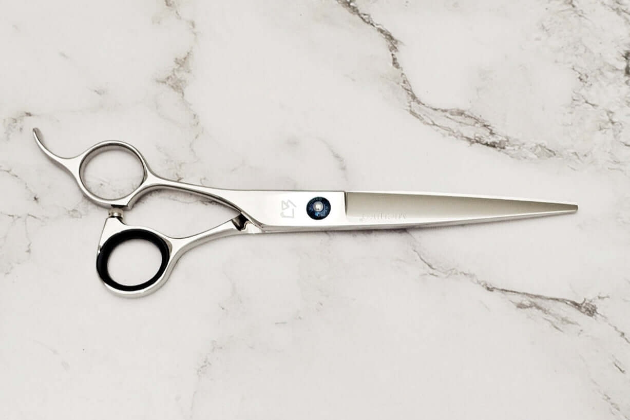Lefty hair scissors on a marble surface