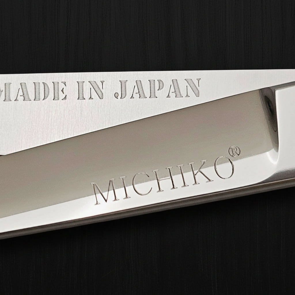 Close-up of Professional Japanese hair cutting shears showing engraved 'Made in Japan' and 'MICHIKO' logos.