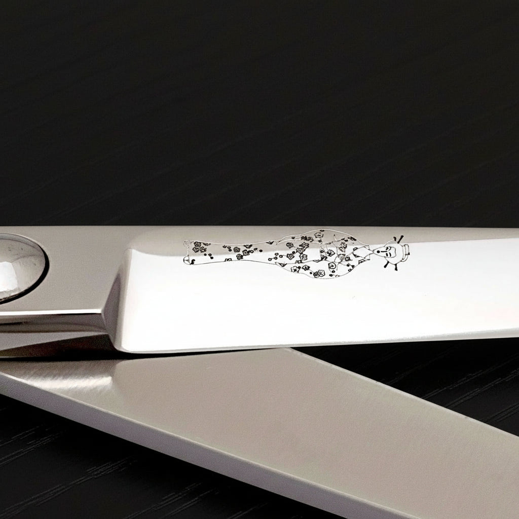 Close-up of Professional Japanese hair cutting shears showcasing the intricate design on the handle.