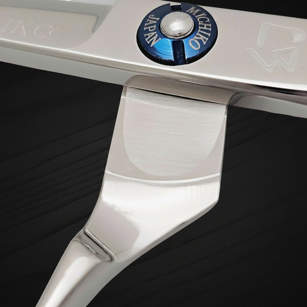 Close-up of a hair cutting scissors with a visible brand logo on a white background