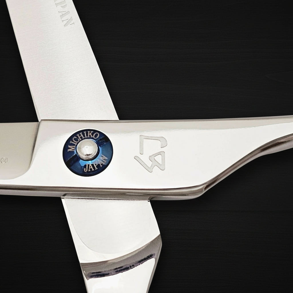 Close-up of a pair of scissors with 'Michiko Japan' branding on a white background