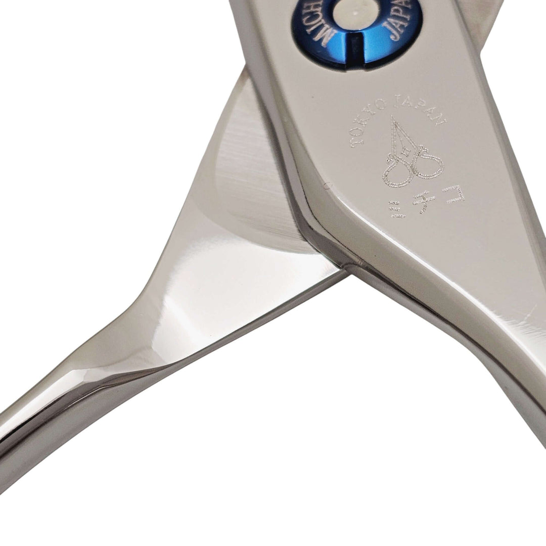 Close-up of a pair of hair scissors with a brand logo on a white background