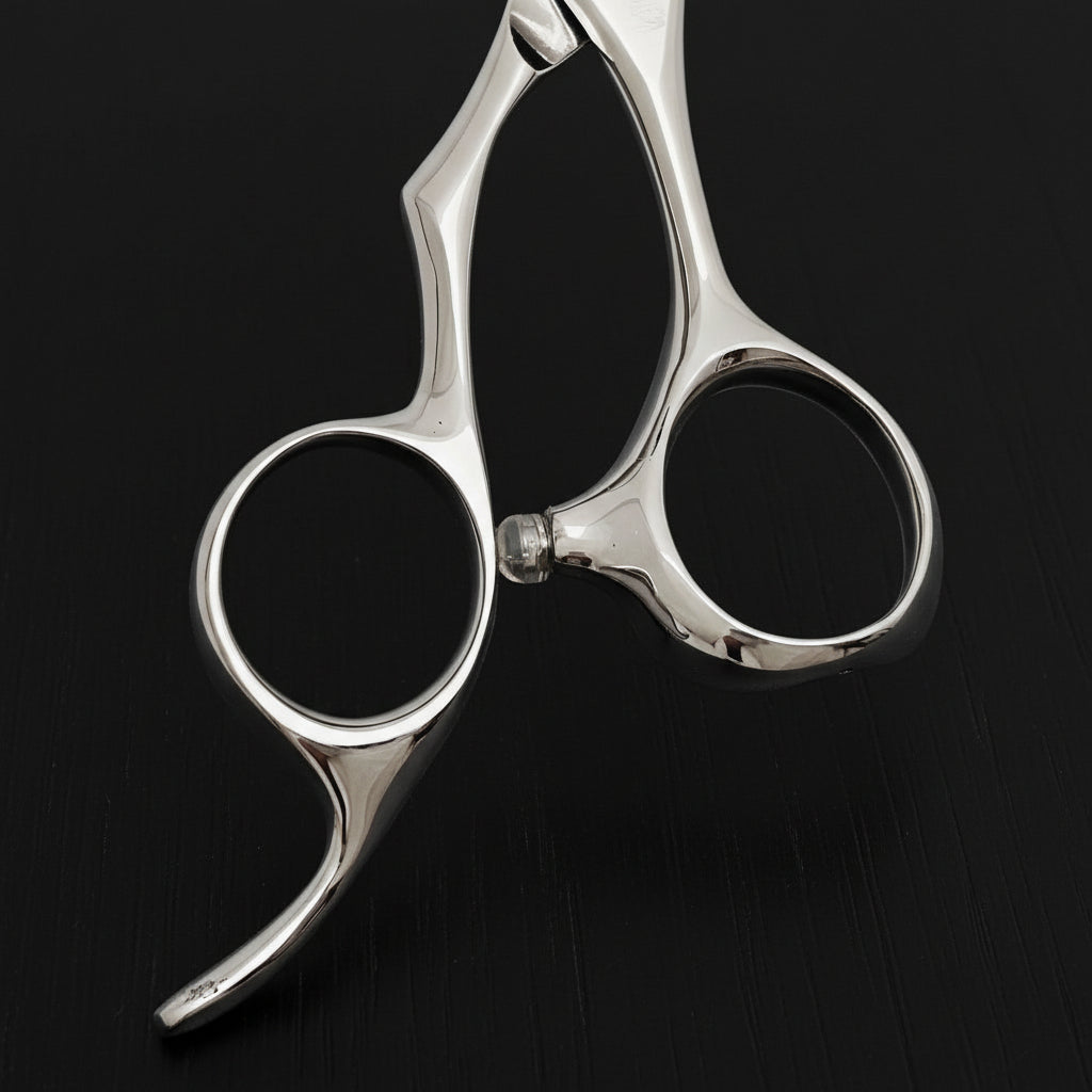Close-up of a pair of silver hair scissors handle part on a white background