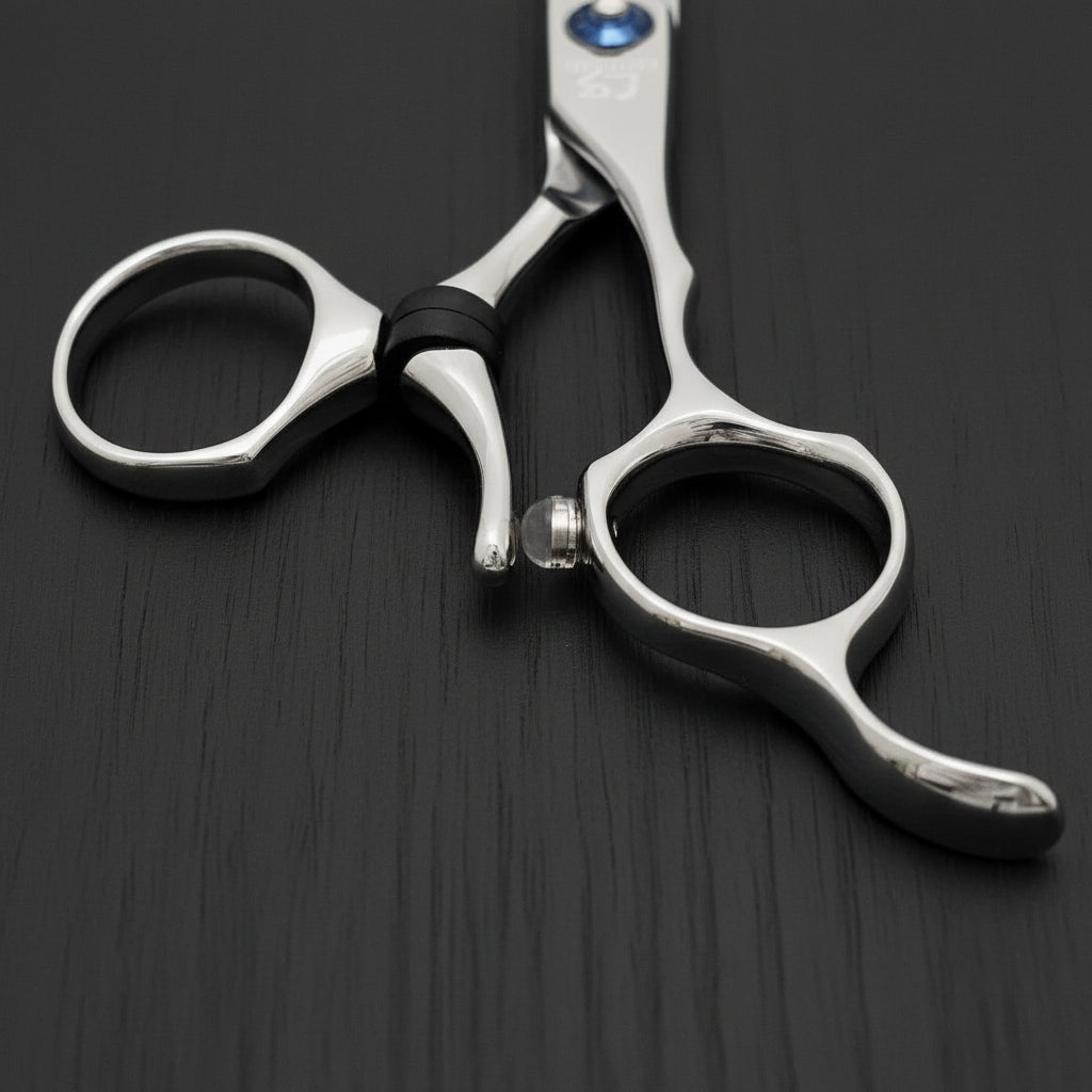 Close-up of a pair of silver swivel hair scissors on a white background