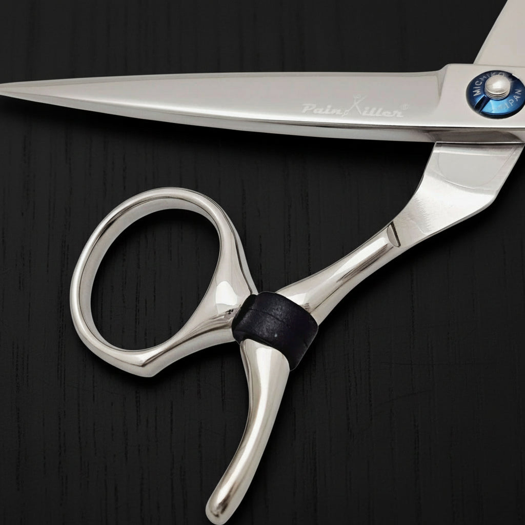 Close-up of a pair of silver swivel hair scissors on a white background