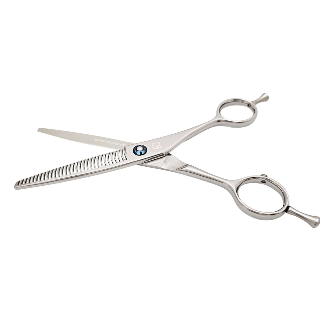 Stainless steel hair thinning scissors on a white background