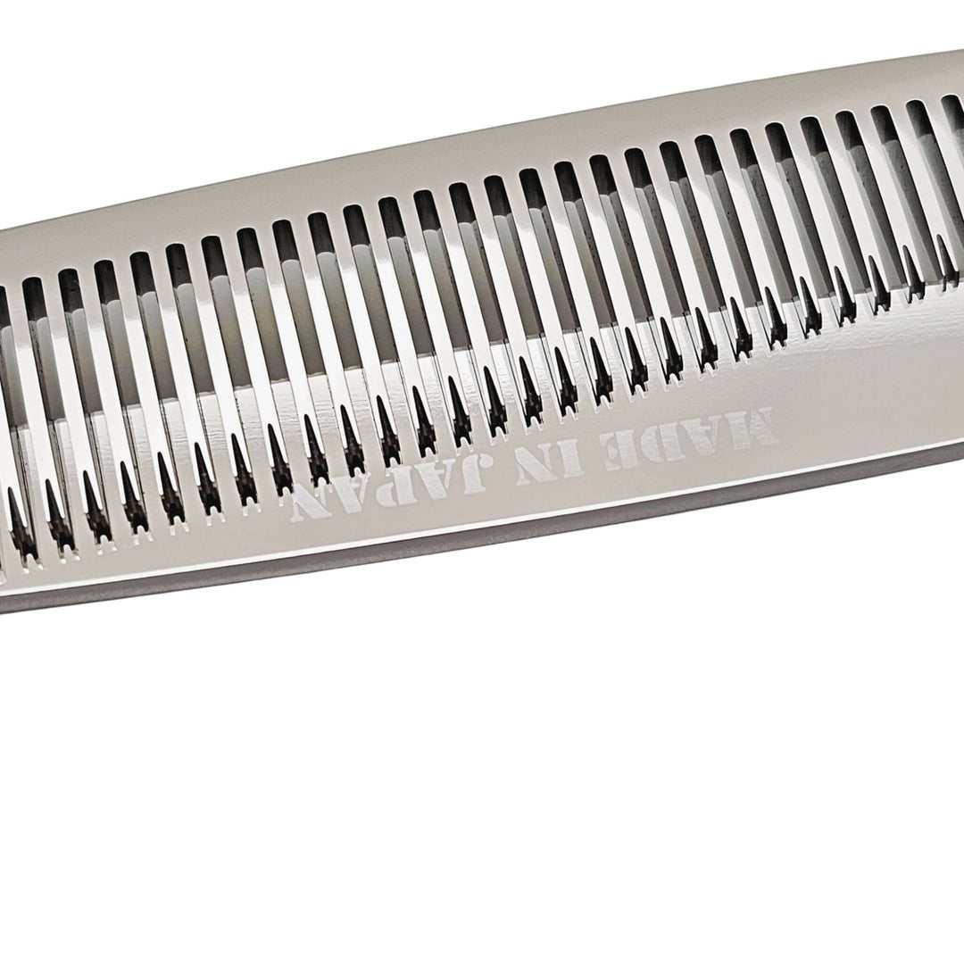Close-up of thinning blade of hair shears with 'Made in Japan' text on a white background