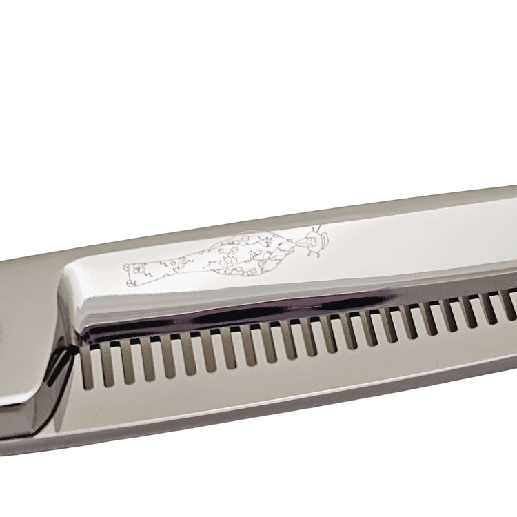 Close-up of hair thinning shears with engraved Japanese lady design on a white background