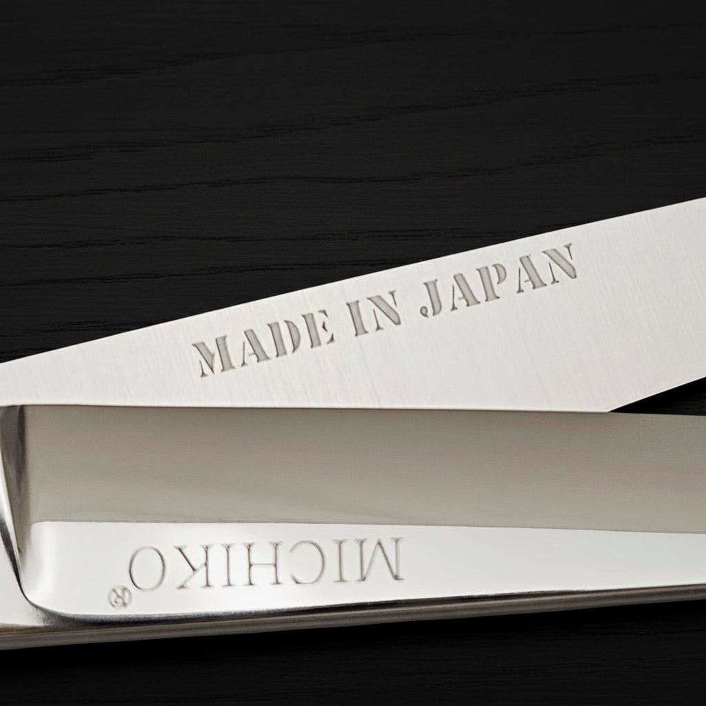 A pair of hair scissors with 'MADE IN JAPAN' and 'MICHIKO' branding on a white background
