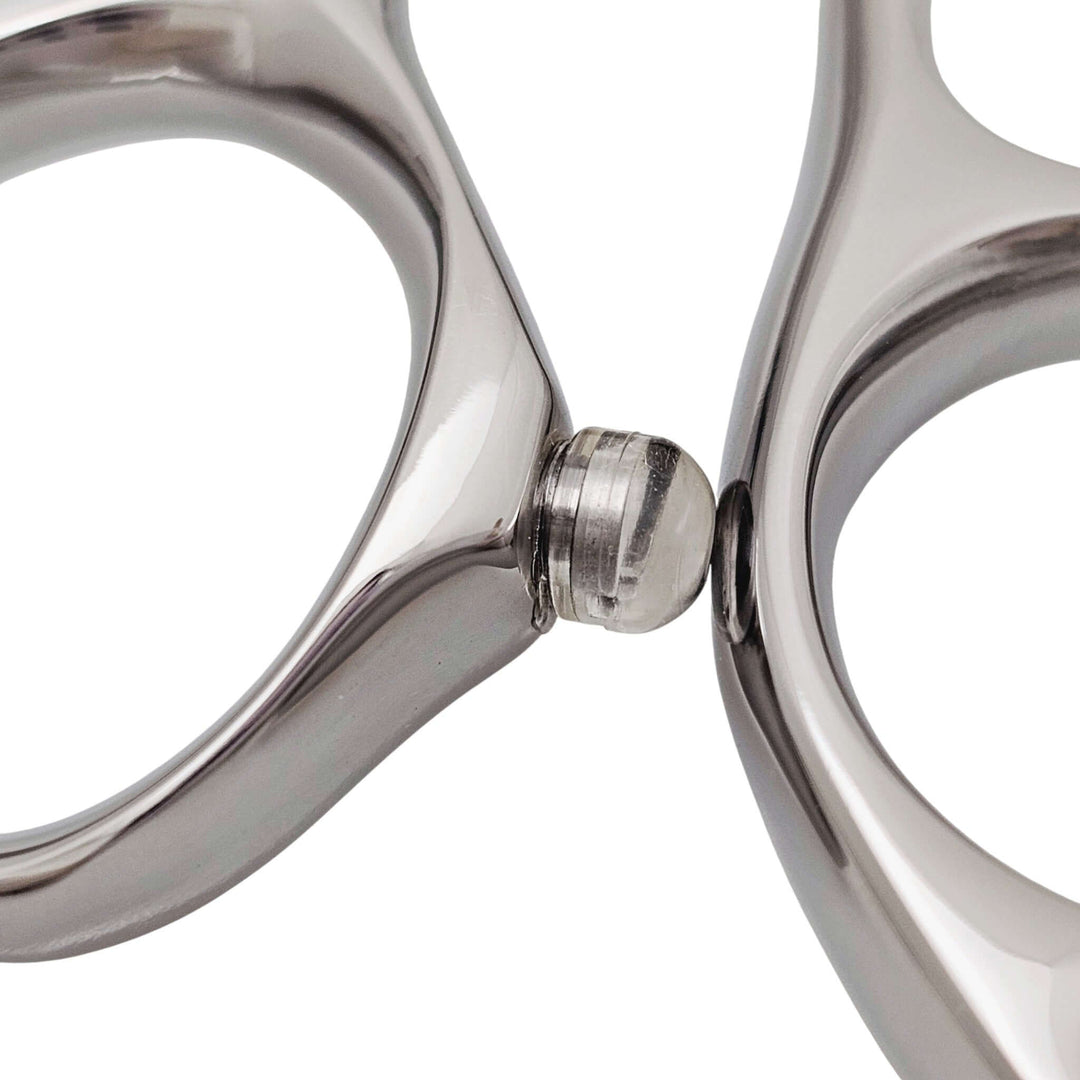 Close-up of screw-in bumper from hair shears on a white background