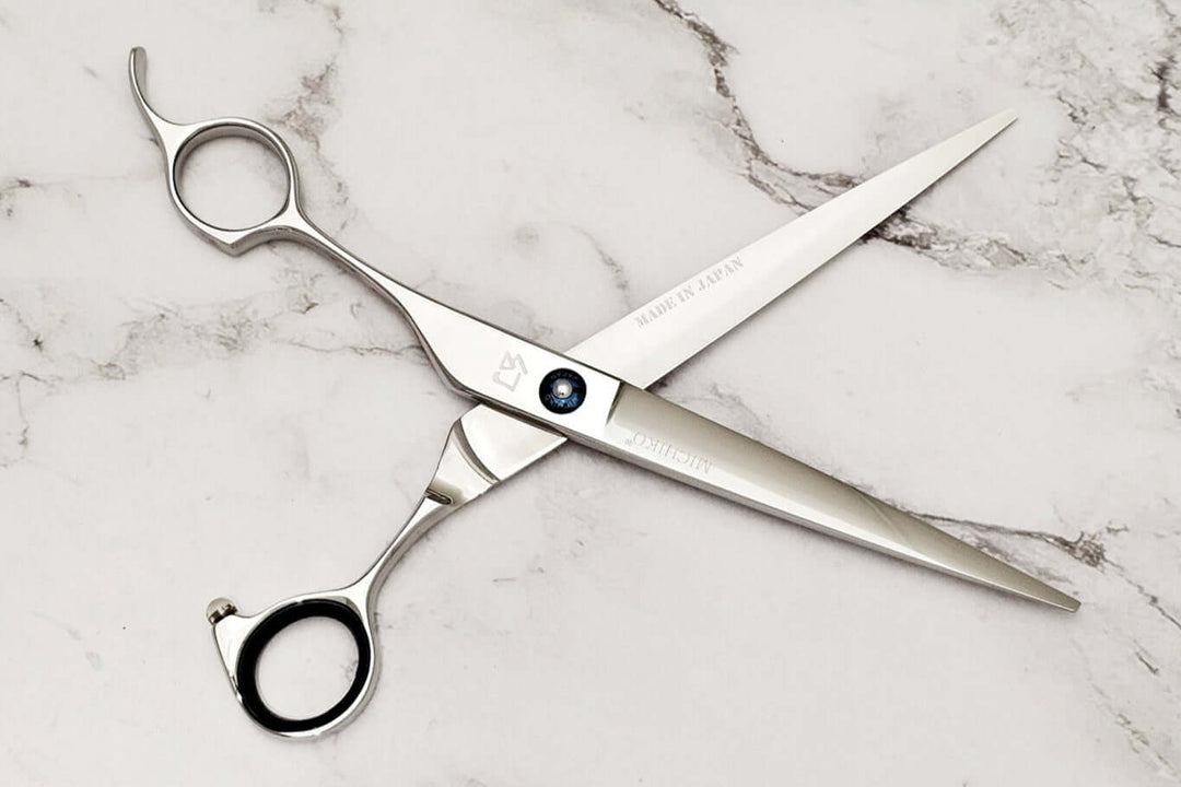 Lefty barber shears on a marble surface