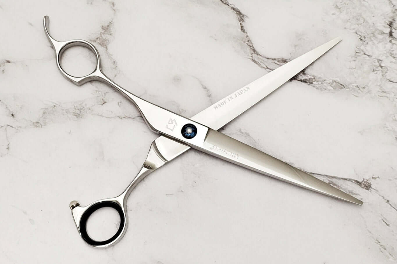 Lefty barber shears on a marble surface