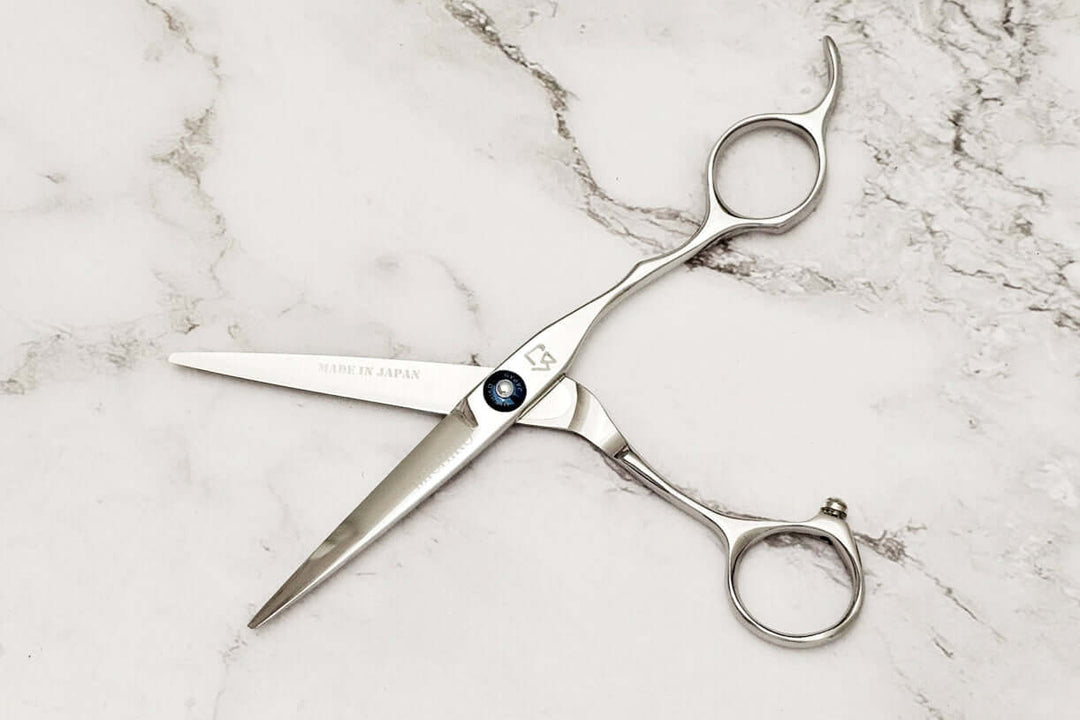 Hair scissors on a marble surface