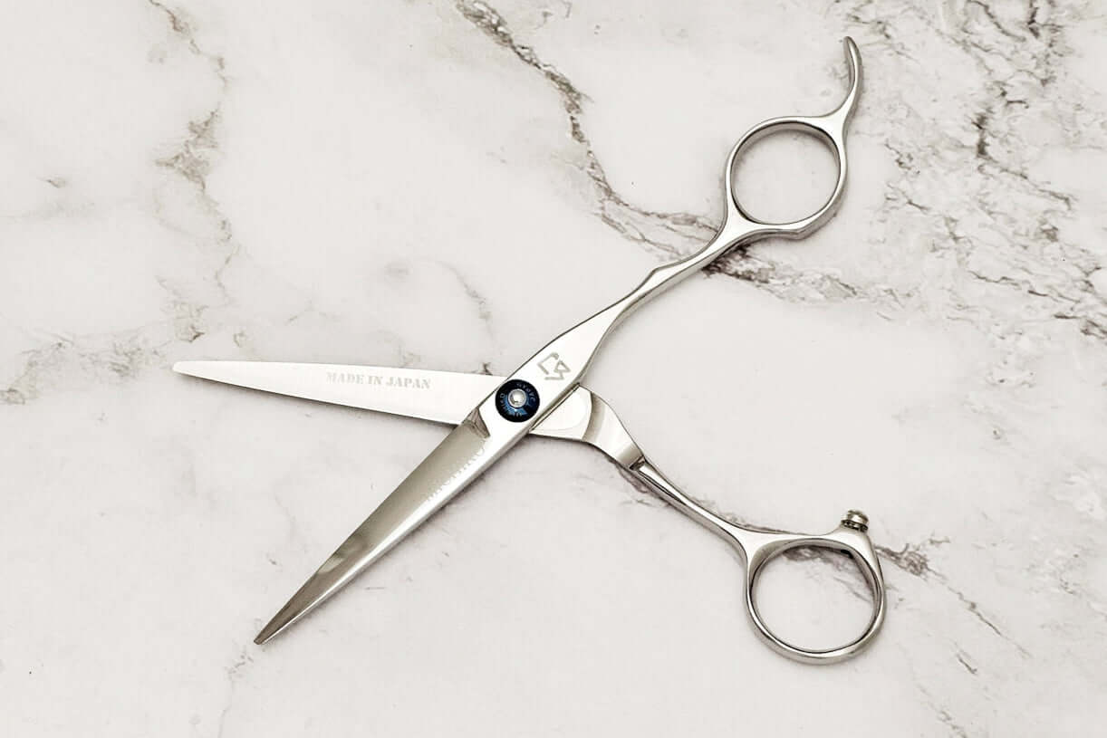 Hair scissors on a marble surface