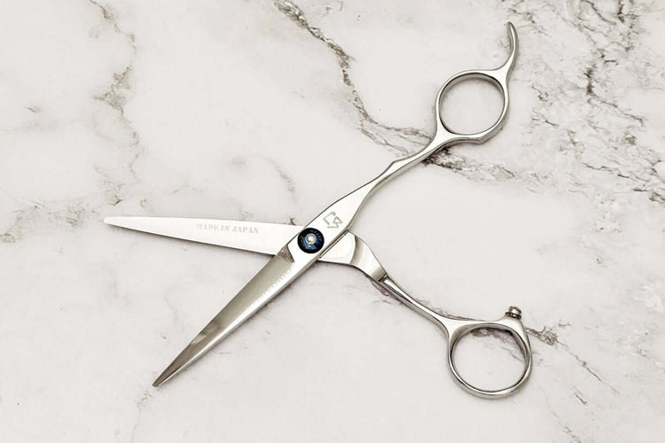 Hair scissors on a marble surface