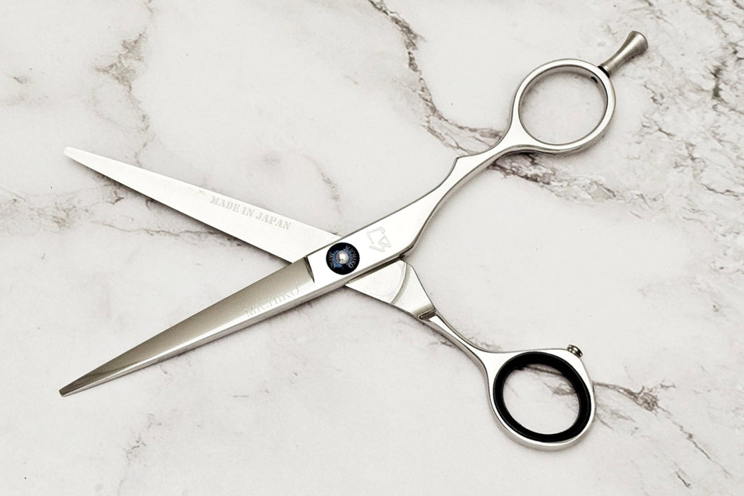 Hair cutting shears on a marble surface