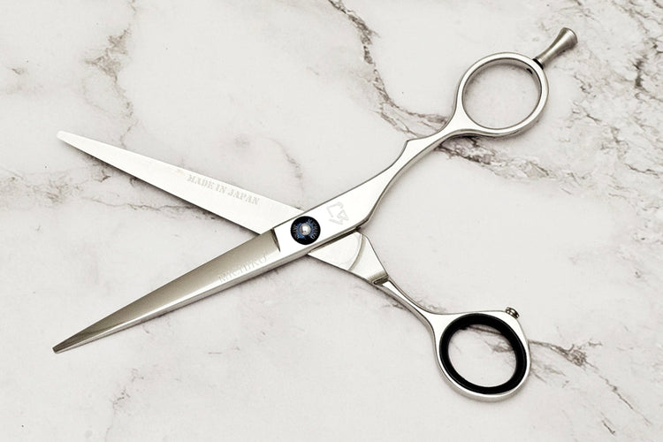 Hair cutting shears on a marble surface