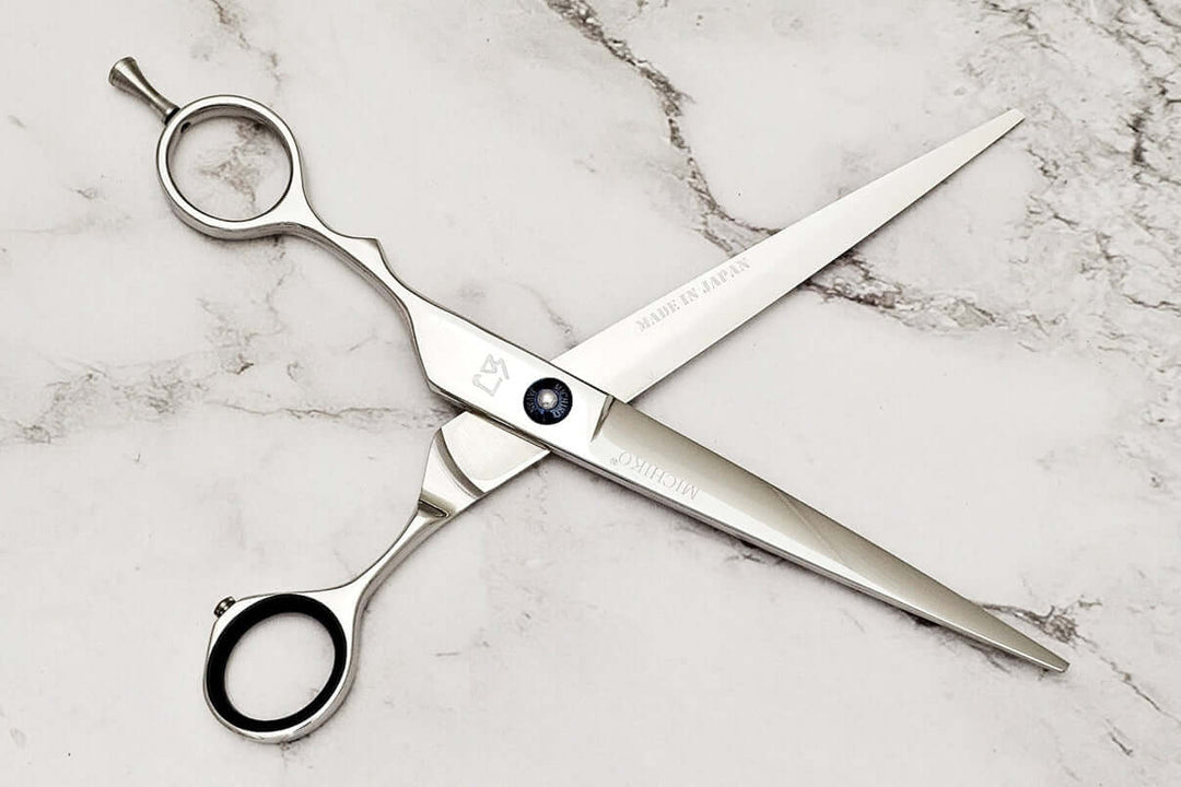 Lefty hair cutting scissors on a marble surface