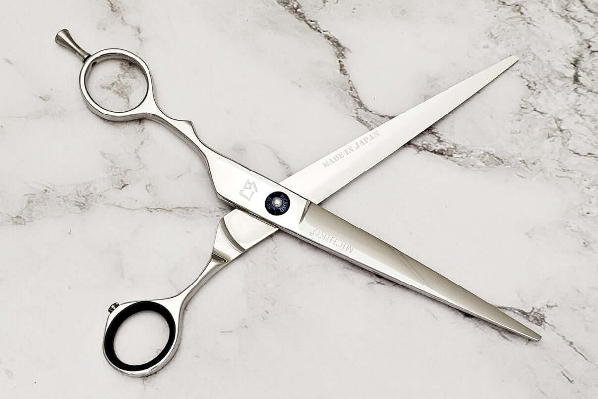 Lefty hair cutting scissors on a marble surface