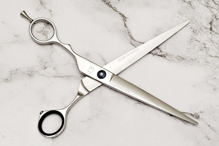 Lefty hair cutting scissors on a marble surface